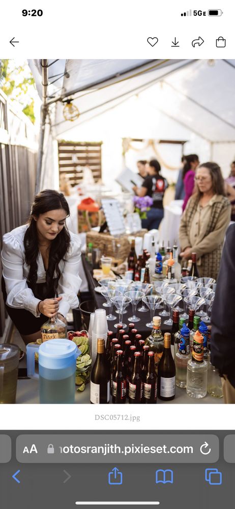 Adina celebrating with guests at a lively event bar station